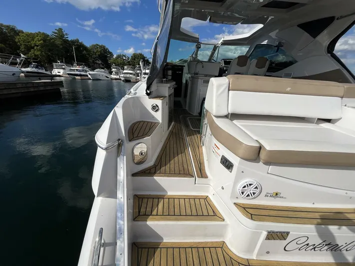  Yacht Photos Pics 2014 Four Winns V435 yacht with teak deck, docked in a marina under a clear blue sky.