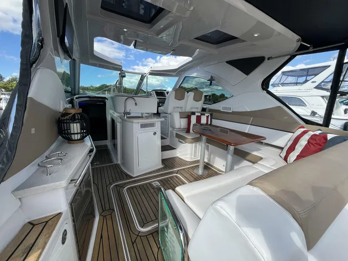  Yacht Photos Pics 2014 Four Winns V435 yacht interior with modern seating and wooden flooring.