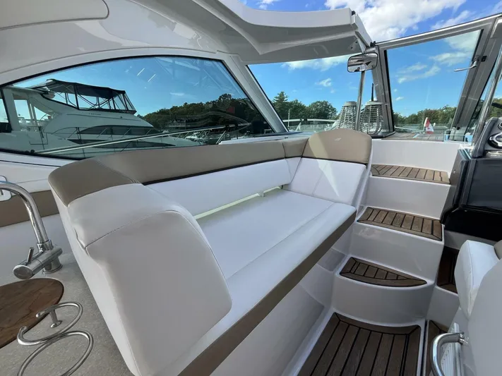  Yacht Photos Pics 2014 Four Winns V435 yacht interior with white seating and wooden steps.