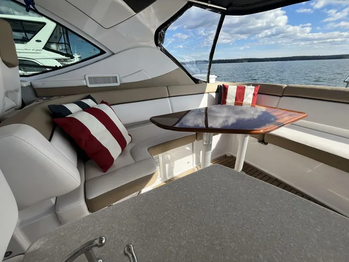  Yacht Photos Pics Luxurious 2014 Four Winns V435 yacht interior with seating, table, and striped cushions.