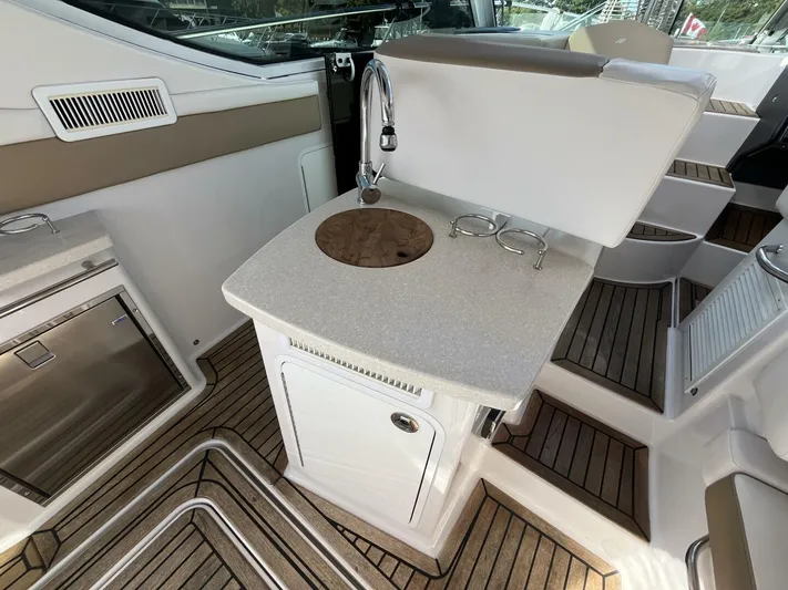  Yacht Photos Pics 2014 Four Winns V435 yacht interior with sink, countertop, and wooden flooring.