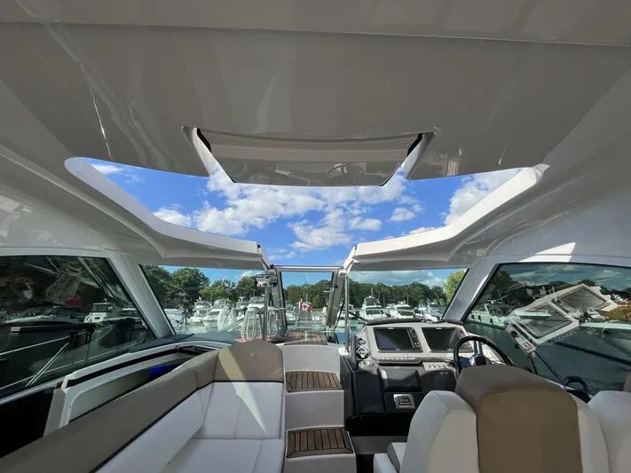  Yacht Photos Pics Interior view of 2014 Four Winns V435 yacht with open sunroof and luxurious seating.
