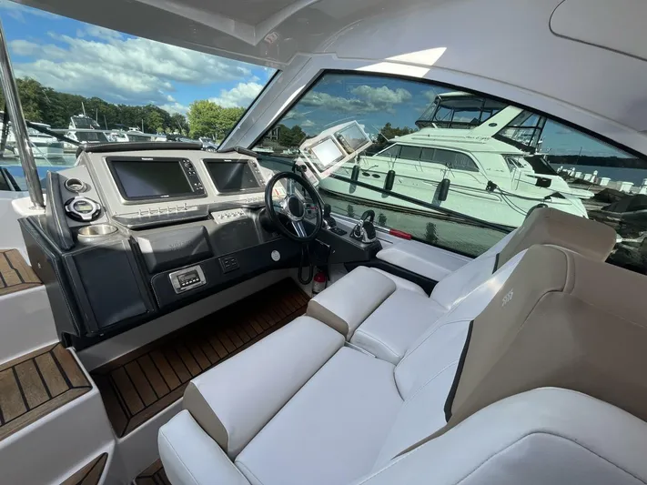  Yacht Photos Pics 2014 Four Winns V435 yacht cockpit with modern controls and white seating.
