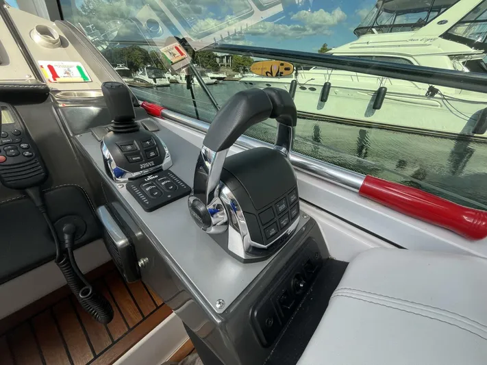  Yacht Photos Pics Control panel of a 2014 Four Winns V435 yacht with throttle levers and joystick.