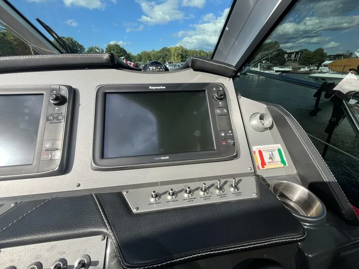  Yacht Photos Pics Control panel of a 2014 Four Winns V435 boat with navigation screens and switches.