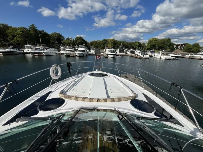  Yacht Photos Pics 2014 Four Winns V435 yacht docked in a marina under a partly cloudy sky.