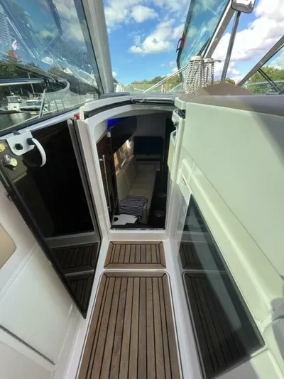  Yacht Photos Pics 2014 Four Winns V435 yacht interior with wooden flooring and open cabin door.