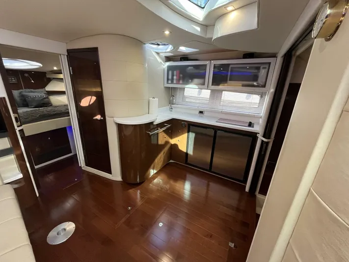  Yacht Photos Pics Luxurious interior of 2014 Four Winns V435 yacht with modern kitchen and wood flooring.