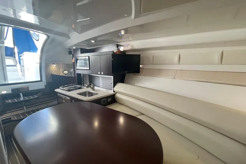  Yacht Photos Pics Interior of 2019 Monterey 295 Sport Yacht with kitchenette and seating area.