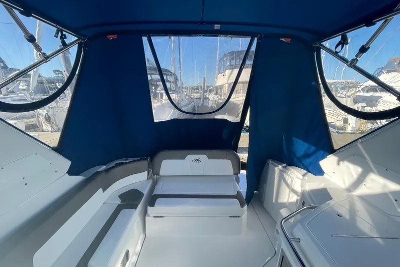  Yacht Photos Pics Interior view of 2019 Monterey 295 Sport Yacht with blue canopy and seating.