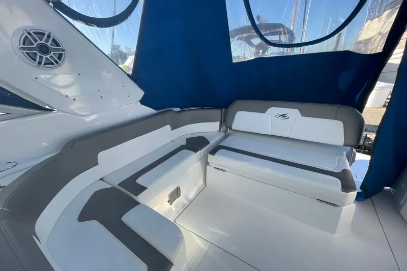  Yacht Photos Pics 2019 Monterey 295 Sport Yacht interior with cushioned seating and blue canopy.