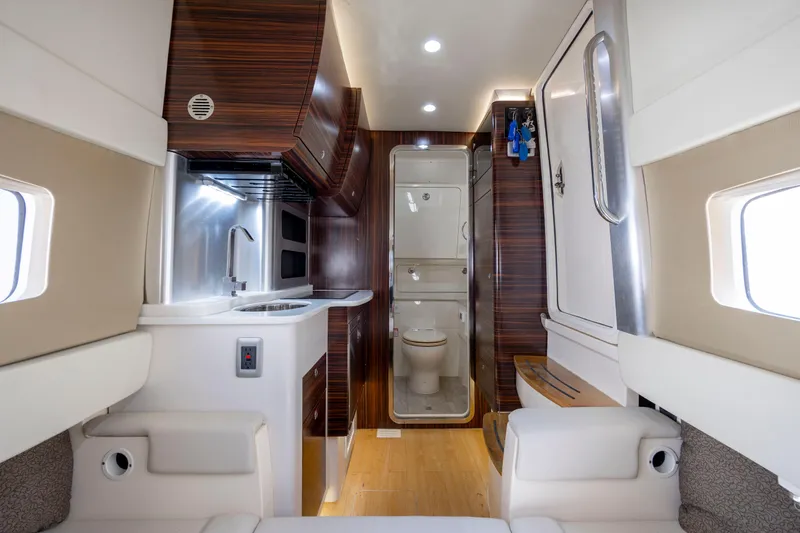  Yacht Photos Pics Luxurious interior of 2019 Scout 420 LXF yacht featuring kitchen and bathroom amenities.