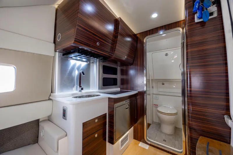  Yacht Photos Pics Luxurious interior of 2019 Scout 420 LXF yacht featuring kitchenette and bathroom.