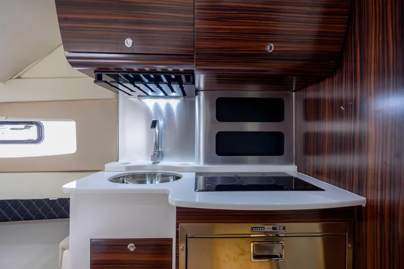  Yacht Photos Pics Luxurious kitchen area in 2019 Scout 420 LXF boat with modern appliances.