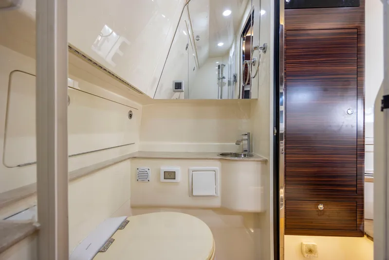  Yacht Photos Pics Luxurious bathroom interior of 2019 Scout 420 LXF yacht with modern fixtures.