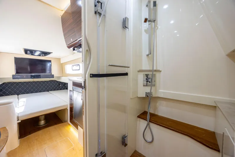  Yacht Photos Pics Luxurious interior of 2019 Scout 420 LXF boat with seating, TV, and shower area.