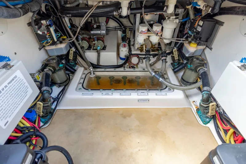  Yacht Photos Pics Engine compartment of a 2019 Scout 420 LXF boat, showcasing complex wiring and components.