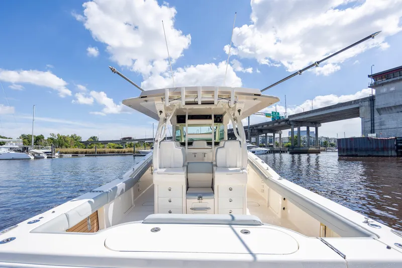  Yacht Photos Pics 2019 Scout 420 LXF boat on water, clear sky, bridge in background.