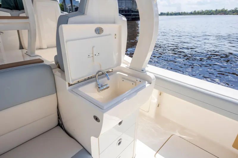  Yacht Photos Pics 2019 Scout 420 LXF boat interior with sink and seating by the water.