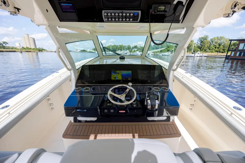  Yacht Photos Pics 2019 Scout 420 LXF boat helm with advanced navigation system and waterfront view.