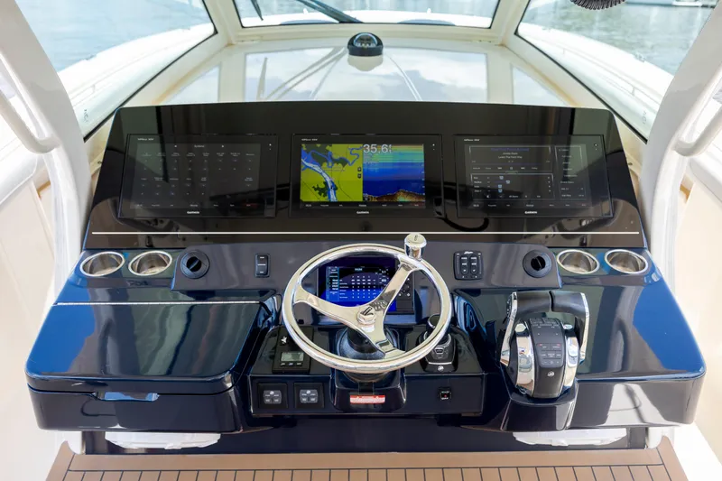  Yacht Photos Pics Helm of 2019 Scout 420 LXF boat with advanced navigation displays and controls.