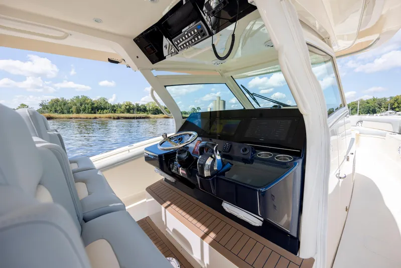  Yacht Photos Pics Interior view of 2019 Scout 420 LXF boat cockpit with modern controls and seating.