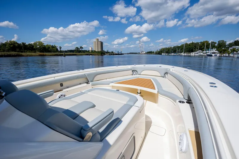  Yacht Photos Pics 2019 Scout 420 LXF boat on calm water under a blue sky with clouds.