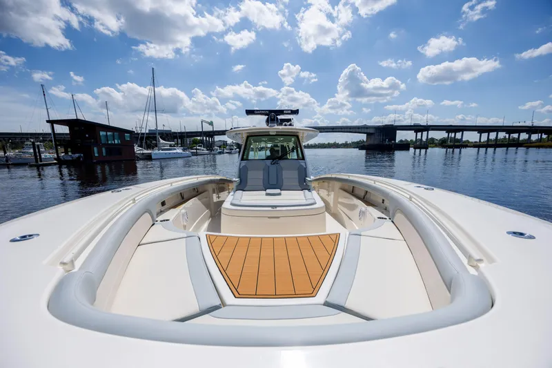  Yacht Photos Pics 2019 Scout 420 LXF boat on calm water under a blue sky with clouds.