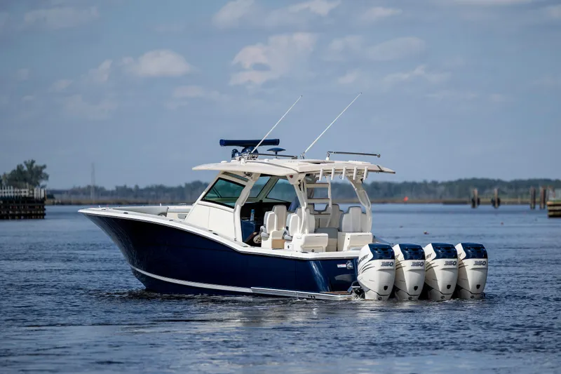  Yacht Photos Pics 2019 Scout 420 LXF boat with four engines on a calm waterway.
