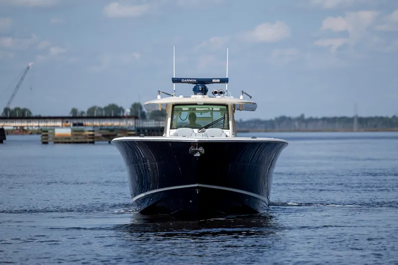 Yacht Photos Pics 2019 Scout 420 LXF boat cruising on calm water under a blue sky.