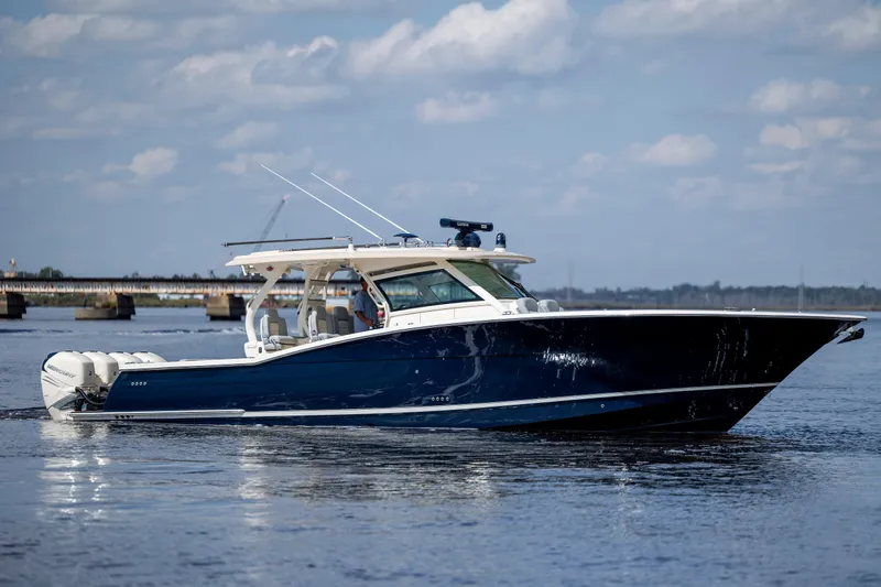  Yacht Photos Pics 2019 Scout 420 LXF boat on calm water under a blue sky.