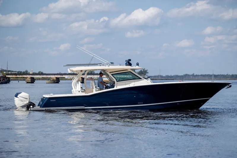  Yacht Photos Pics 2019 Scout 420 LXF boat cruising on calm water under a blue sky.