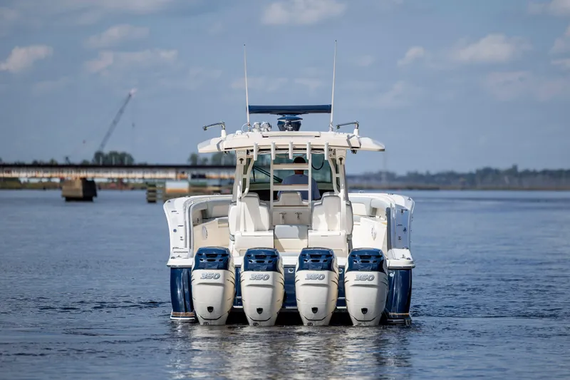  Yacht Photos Pics 2019 Scout 420 LXF boat with four powerful engines on a calm waterway.