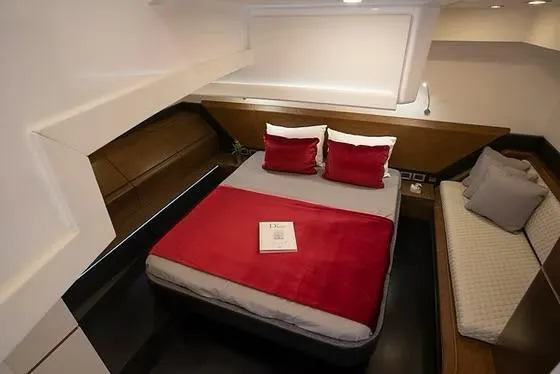  Yacht Photos Pics Luxurious cabin interior of 2026 Schaefer 510 GT Pininfarina yacht with red accents.