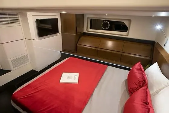  Yacht Photos Pics Luxurious cabin interior of 2026 Schaefer 510 GT Pininfarina yacht with red bedding.