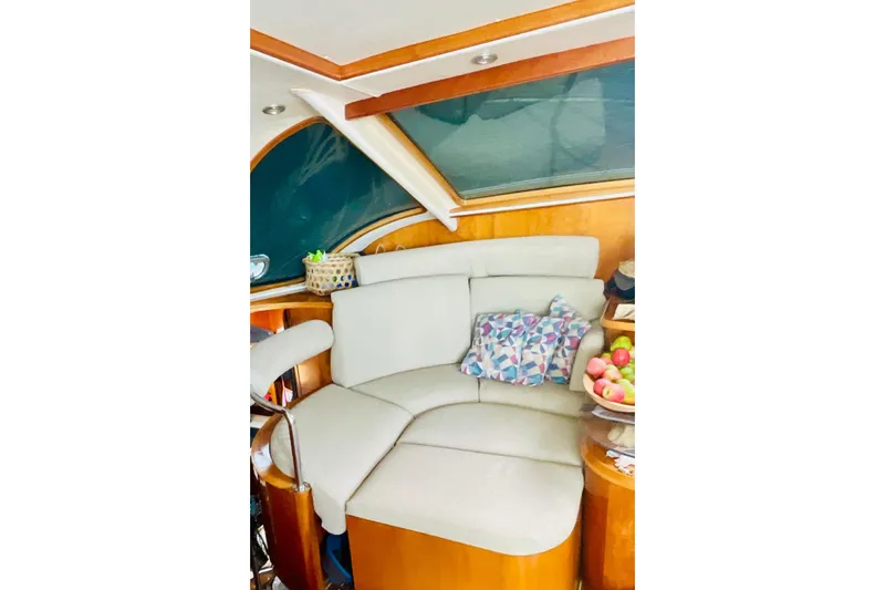 Macera Yacht Photos Pics Cozy seating area on 2008 Privilege 495 yacht with decorative pillows and fruit basket.