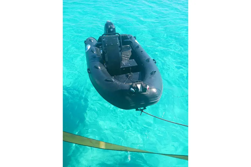 Macera Yacht Photos Pics Black inflatable boat on clear turquoise water, Privilege 495, 2008 model.