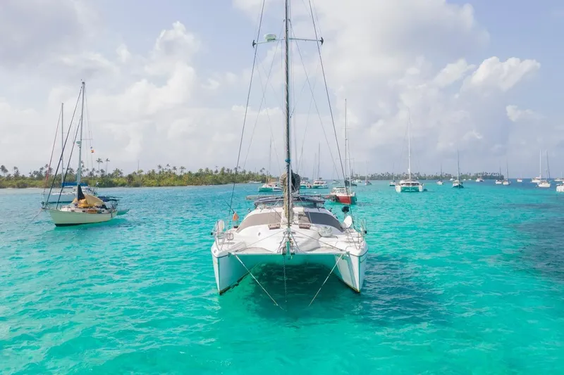 Macera Yacht Photos Pics Sailboats anchored in turquoise waters, featuring a 2008 Privilege 495 catamaran.