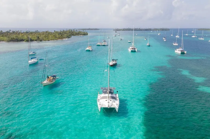 Macera Yacht Photos Pics Sailboats anchored in turquoise waters near lush islands, featuring a 2008 Privilege 495.