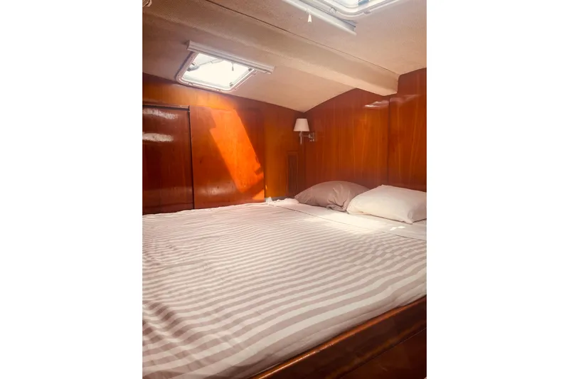 Macera Yacht Photos Pics Cozy cabin interior of 2008 Privilege 495 yacht with wooden paneling and skylight.