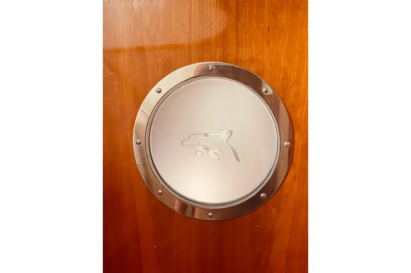 Macera Yacht Photos Pics Porthole with dolphin design on 2008 Privilege 495 yacht interior.