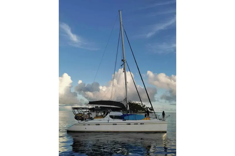 Macera Yacht Photos Pics Sailing catamaran Privilege 495, 2008 model, on calm waters under a blue sky.