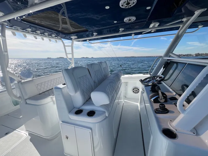  Yacht Photos Pics 2023 Yellowfin 42 Offshore boat interior with helm, seating, and ocean view.