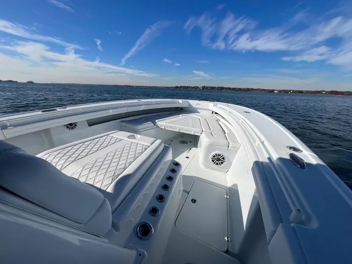  Yacht Photos Pics 2023 Yellowfin 42 Offshore boat on open water under clear blue sky.