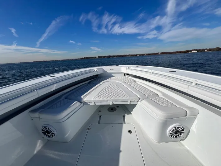  Yacht Photos Pics 2023 Yellowfin 42 Offshore boat with cushioned seating on open water.