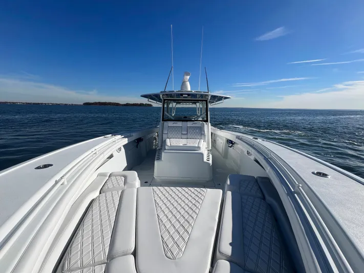  Yacht Photos Pics 2023 Yellowfin 42 Offshore boat on open water under clear blue sky.