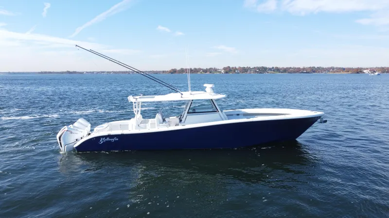  Yacht Photos Pics 2023 Yellowfin 42 Offshore boat on open water, side view.