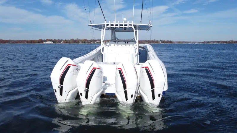  Yacht Photos Pics 2023 Yellowfin 42 Offshore boat with four powerful outboard engines on open water.