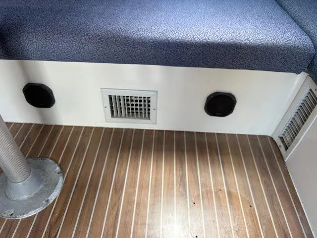  Yacht Photos Pics Interior of 1995 Lagoon TPI 37 with wooden flooring and cushioned seating.