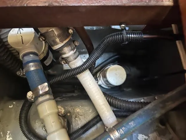  Yacht Photos Pics Engine compartment of a 1995 Lagoon TPI 37 with hoses and clamps visible.